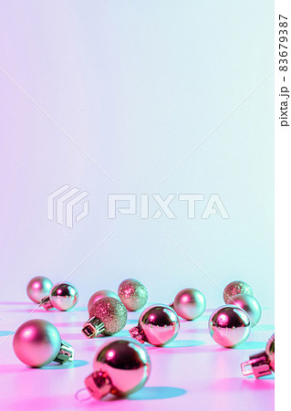 Christmas balls pattern neon background. Xmas bauble on abstract holiday winter gradient backdrop. Happy new year copy space. 83679387