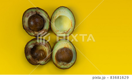 Ugly food on yellow background. Bad avocado. Rotten tropical fruits. Concept of rotten fruit. Copy space on yellow background. Ugly food on yellow background. Bad avocado. Rotten tropical fruits. Concept of rotten fruit. Copy space on yellow background. 83681629
