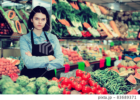 Female seller displaying assortment 83689371