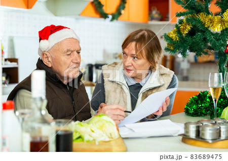 Couple working with papers before Christmas 83689475