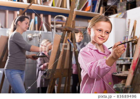 schoolgirls diligently training their painting skills during class at art studio schoolgirls diligently training their painting skills during class at art studio 83689496