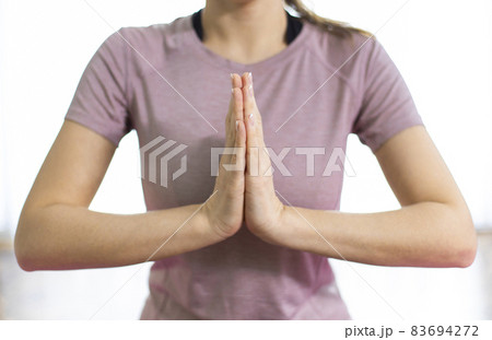Yogi woman doing namaste gesture at home Yogi woman doing namaste gesture at home 83694272
