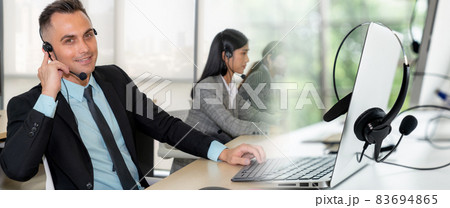Business people wearing headset working in office broaden view Business people wearing headset working in office broaden view 83694865