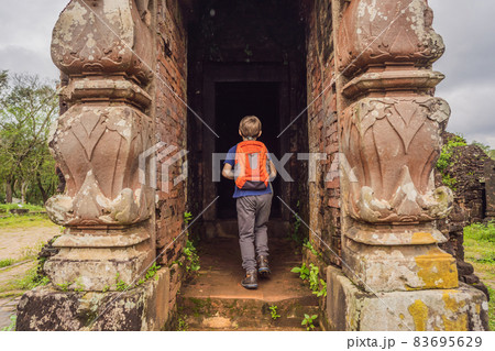 Boy tourist in Temple ruin of the My Son complex, Vietnam. Vietnam opens to tourists again after quarantine Coronovirus COVID 19 Boy tourist in Temple ruin of the My Son complex, Vietnam. Vietnam opens to tourists again after quarantine Coronovirus COVID 19 83695629