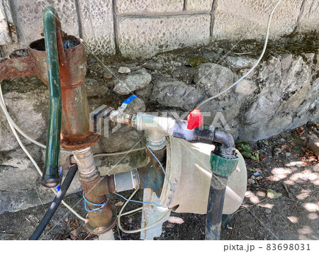 Homemade old water pump made of wire and pipe pieces 83698031