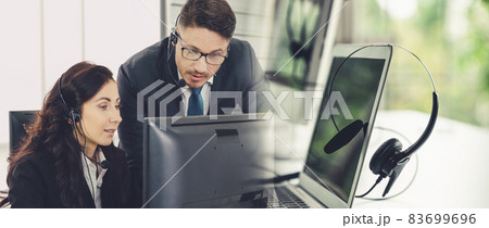 Business people wearing headset working in office broaden view Business people wearing headset working in office broaden view 83699696