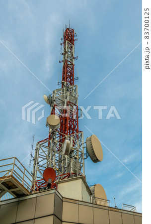 Large telecommunication tower against sky and clouds in background Large telecommunication tower against sky and clouds in background 83700125