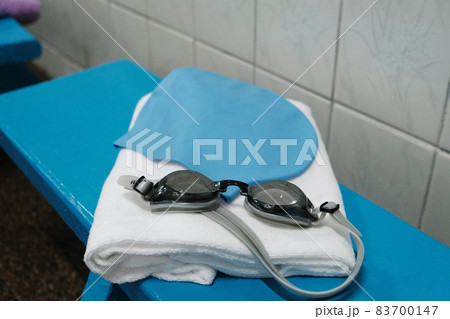 Things for the pool - a towel, a rubber cap and swimming goggles. Things for the pool - a towel, a rubber cap and swimming goggles. 83700147