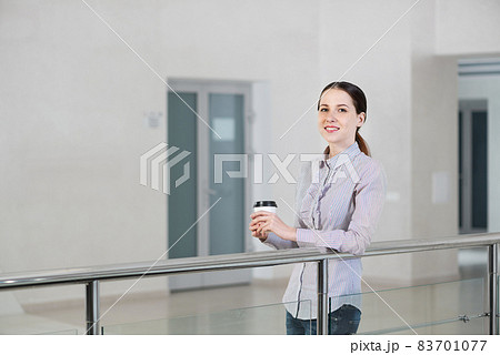 young attractive business woman with a cup of coffee young attractive business woman with a cup of coffee 83701077