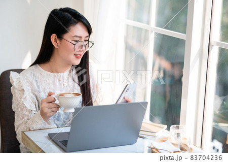 Happy of asian freelance people Businesswoman writing message on smartphone and hold a coffee cup mug casual working with laptop computer at the cafe,Business Lifestyle Happy of asian freelance people Businesswoman writing message on smartphone and hold a coffee cup mug casual working with laptop computer at the cafe,Business Lifestyle 83704236