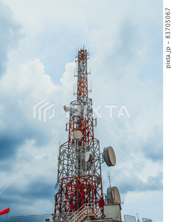 Large telecommunication tower against sky and clouds in background Large telecommunication tower against sky and clouds in background 83705067