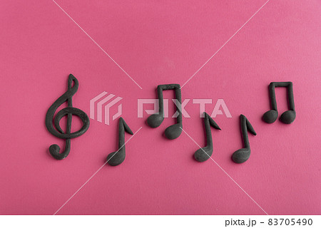 Treble clef and music notes on pink background. Music symbol. Key of G. Violin key. Musical notation. Treble clef and music notes on pink background. Music symbol. Key of G. Violin key. Musical notation. 83705490