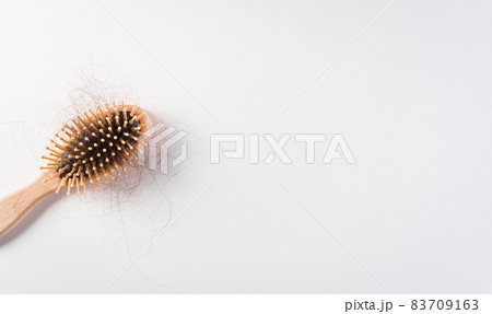 Healthcare problem concept. Hair loss or hair fall in comb on white background. 83709163