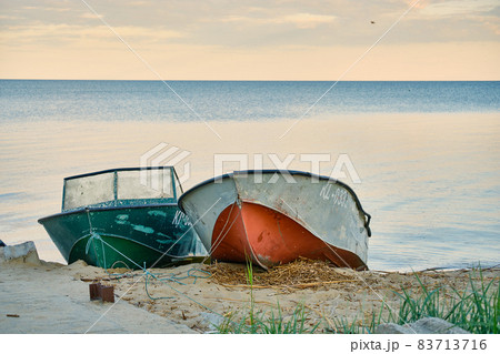 Two old metal boats on the seashore on the Curonian Spit of the Kaliningrad region. 83713716