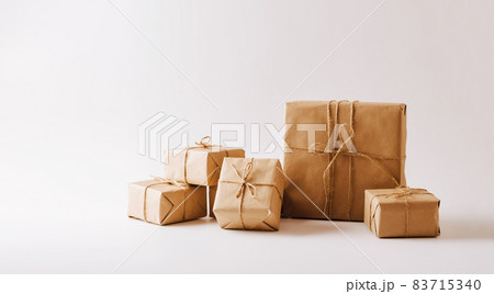 Gifts in eco-friendly paper packaging on a white background. Copy space concept minimalism Gifts in eco-friendly paper packaging on a white background. Copy space concept minimalism 83715340