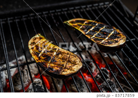 Eggplant on barbecue, outdoor BBQ grill with fire. Top view Eggplant on barbecue, outdoor BBQ grill with fire. Top view 83717859