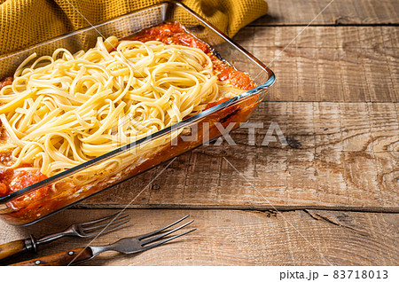 Oven baked feta Spaghetti pasta in baking dish. Wooden background. Top view. Copy space 83718013