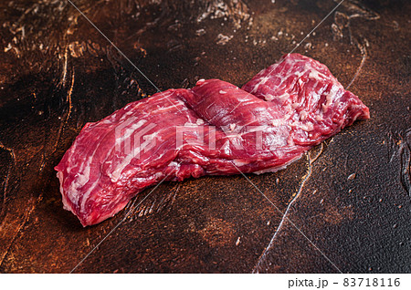 Raw machete skirt beef steak on butcher table. Dark background. Top view 83718116