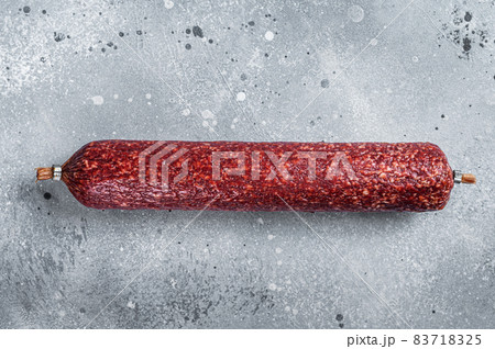 Dry salami sausage. Gray background. Top view Dry salami sausage. Gray background. Top view 83718325