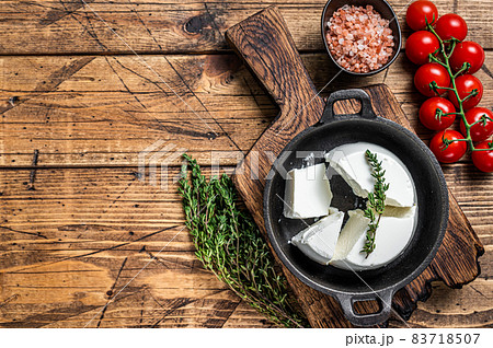 Fresh Ricotta cream Cheese in a pan with basil and tomato. wooden background. Top view. Copy space Fresh Ricotta cream Cheese in a pan with basil and tomato. wooden background. Top view. Copy space 83718507
