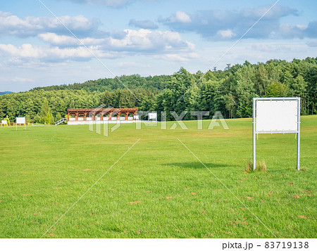 Advertisement flags of Golf club blowing at tee practise range. Practise shot course green Advertisement flags of Golf club blowing at tee practise range. Practise shot course green 83719138