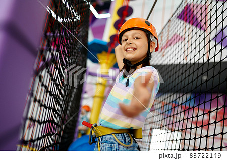 Little girl climbs on the ropes, zip line 83722149