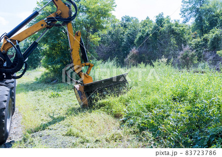 Suburban highway road maintenance service of tractor mechanization machine mower mowing grass Suburban highway road maintenance service of tractor mechanization machine mower mowing grass 83723786