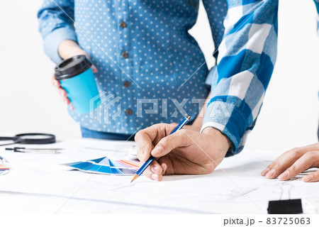 Designers discuss architecture project in office 83725063
