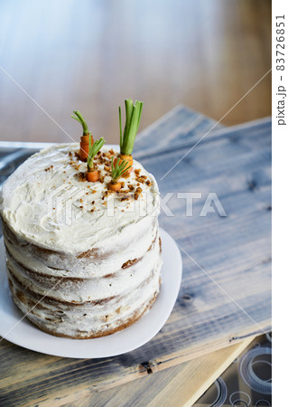Carrot cake stands on a white plate on the table. View from above Carrot cake stands on a white plate on the table. View from above 83726851