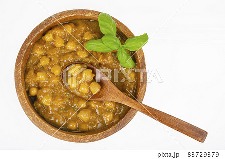 Chickpeas with curry sauce in wooden bowl. Studio Photo Chickpeas with curry sauce in wooden bowl. Studio Photo 83729379