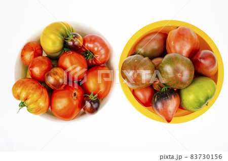 Colored tomatoes of different varieties on white background. Studio Photo 83730156