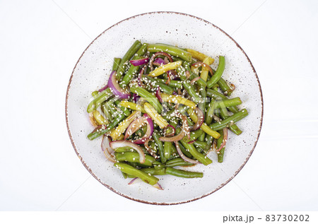 Vegetarian green bean pod dish with red pickled onions and sesame seeds. Studio Photo Vegetarian green bean pod dish with red pickled onions and sesame seeds. Studio Photo 83730202