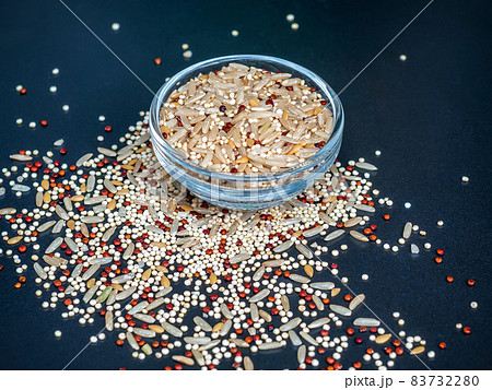 Omega-3 superfood for vegan and vegetarian. Blend of grains quinoa, brown rice and flax in a glass bowl on a stone dark table. Close-up 83732280