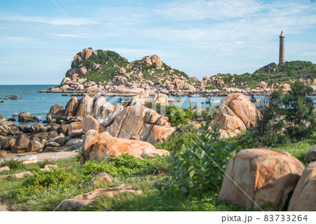 Scenic view of the lighthouse on the beautiful shore with large stones. The beauty of nature. Amazing places in the world. bay with crystal water Scenic view of the lighthouse on the beautiful shore with large stones. The beauty of nature. Amazing places in the world. bay with crystal water 83733264