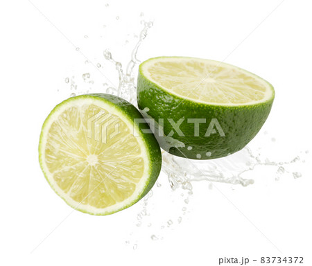 Lime half and a slice are falling on a white background. Isolated 83734372