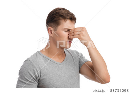 Despaired sad millennial european male presses hand to nose, suffers from migraine or runny nose Despaired sad millennial european male presses hand to nose, suffers from migraine or runny nose 83735098