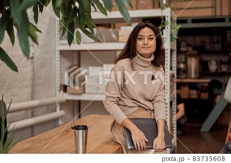 Female freelancer taking break in workspace 83735608