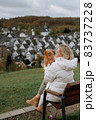 young woman with a pretty pom spitz in beautiful old german town Freudenberg 83737228
