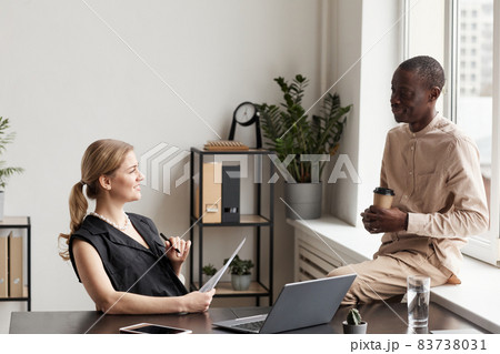 Two Business People on Break in Office Two Business People on Break in Office 83738031
