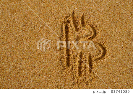 Bitcoin sign written on sand in evening sunlight Bitcoin sign written on sand in evening sunlight 83741089