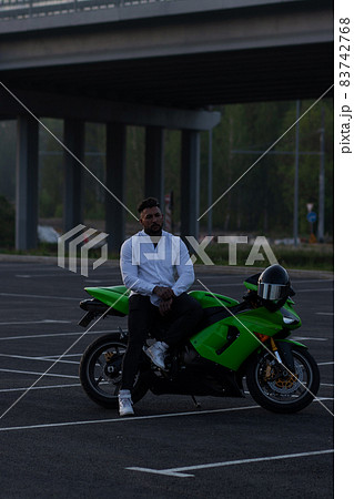 Stylish man on motorbike in evening Stylish man on motorbike in evening 83742768