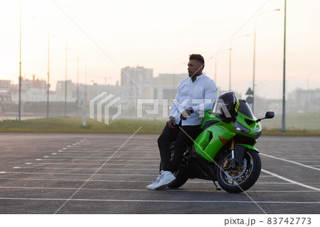 Stylish man on motorbike in evening 83742773