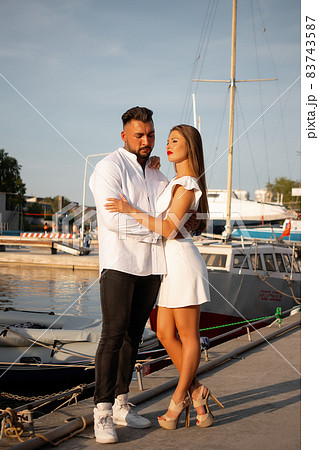 Couple standing in port in summer 83743587