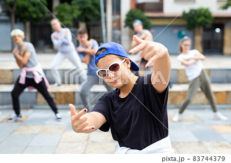 Modern teen girl krump dancer performing with group 83744379