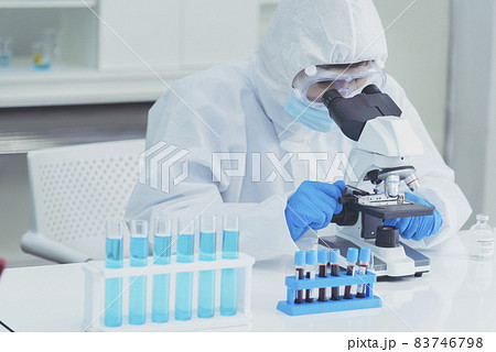 Male Scientist look into Microscope research in science laboratory. Asian scientist looking equipment laboratory chemistry labs. Covid-19 coronavirus biochemistry research experiment vaccine concept Male Scientist look into Microscope research in science laboratory. Asian scientist looking equipment laboratory chemistry labs. Covid-19 coronavirus biochemistry research experiment vaccine concept 83746798