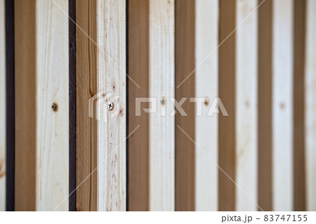 Building wall decorated with wooden furring on house terrace 83747155