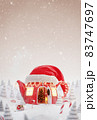 Cute cozy fairy house in red elfs hat decorated at christmas 83747697