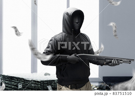 Criminal man in a hidden mask holding the shotgun while robbery the money Criminal man in a hidden mask holding the shotgun while robbery the money 83751510