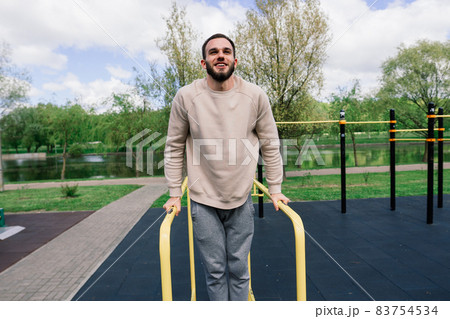 Caucasian sportsman on crossbar during street workout. Healthy lifestyle and street sport concept 83754534