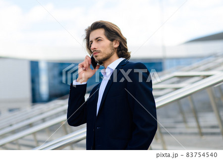 Portrait of an handsome businessman in the city. 83754540